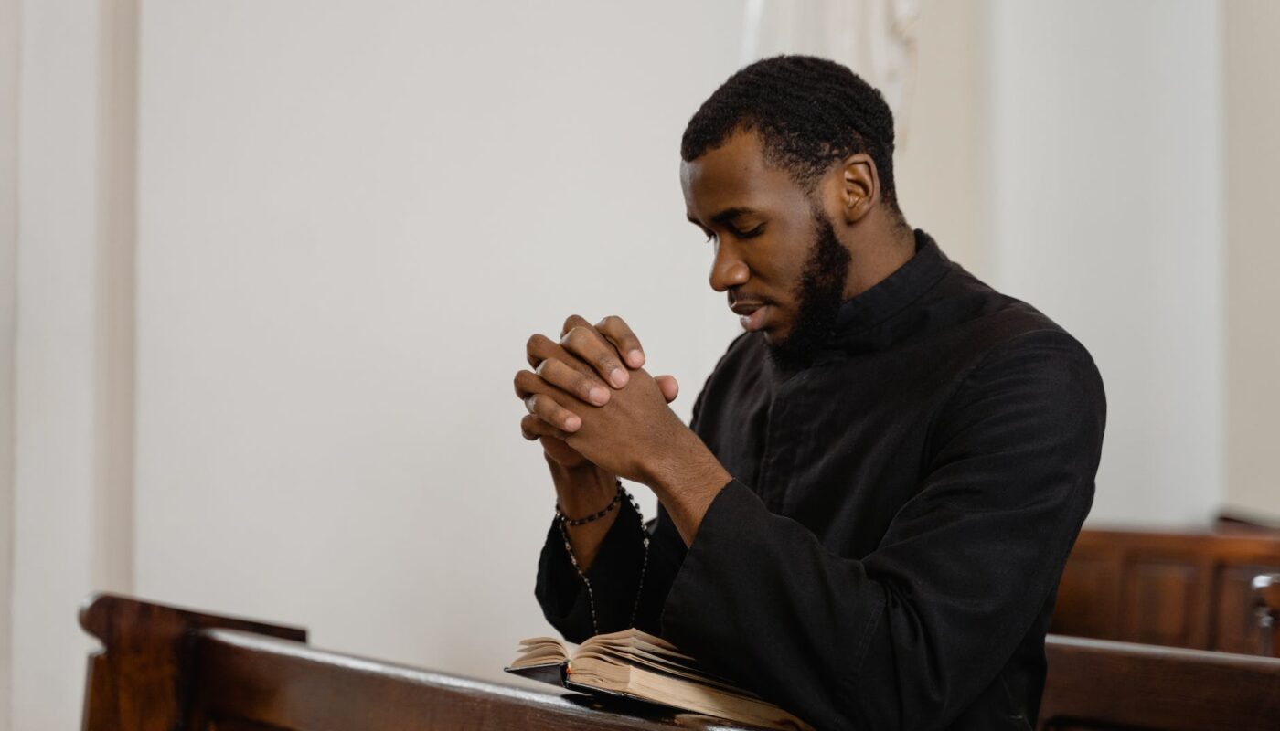 a religious man praying solemnly