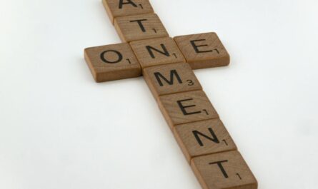 close up of a cross made of letters forming a word atonement