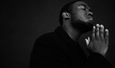 black man praying with eyes closed