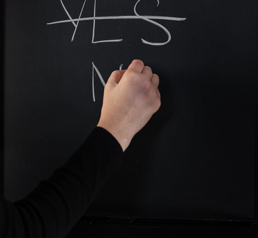 person writing on chalkboard