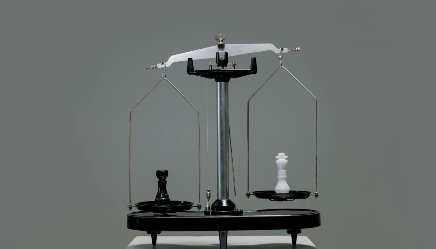 chess pieces on a scale