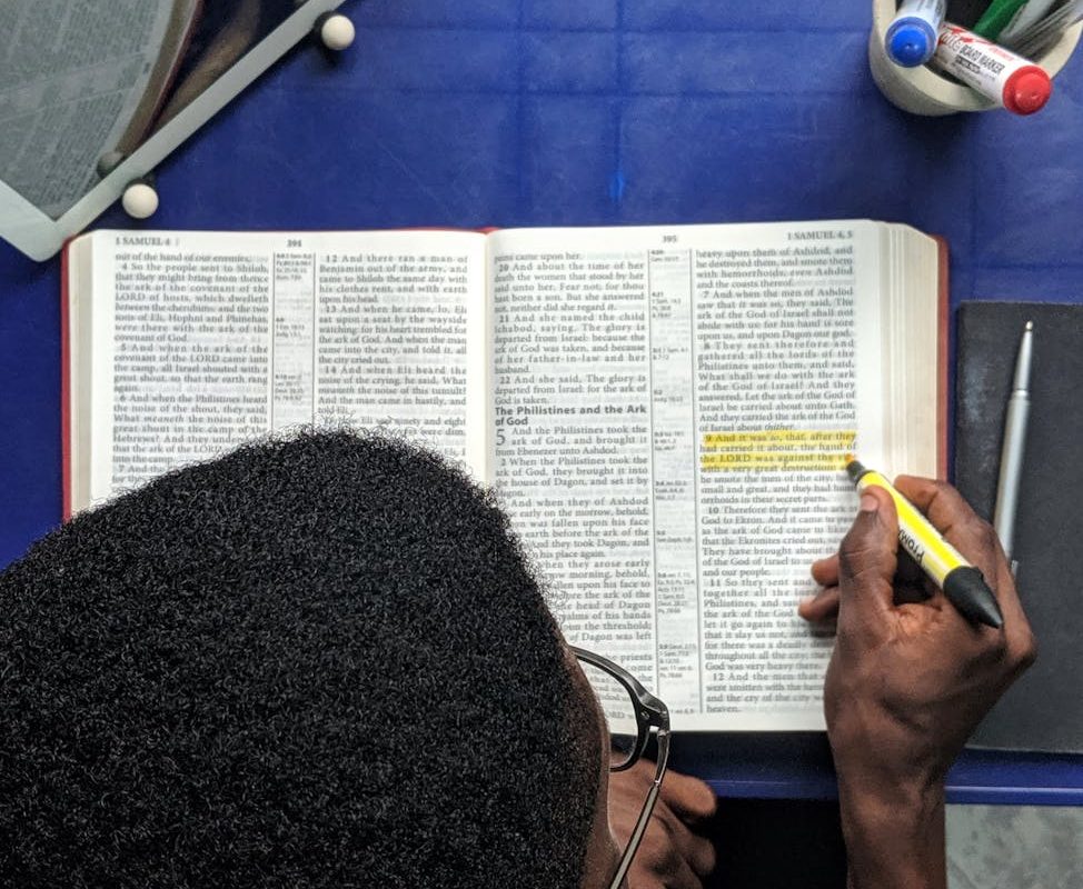 top view photo of man reading a book