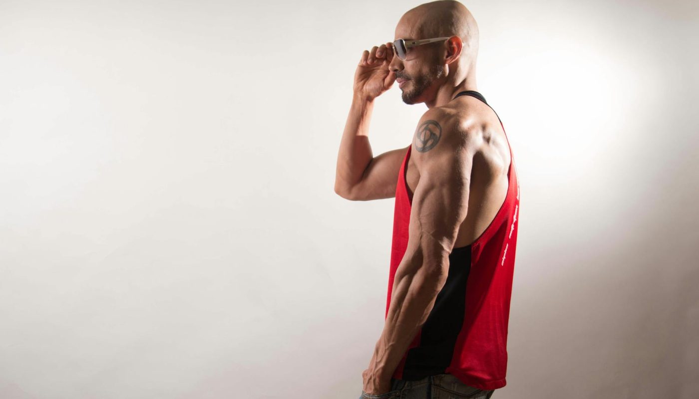 brawny man in sunglasses and red tank