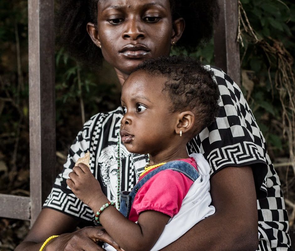 mother and child in thoughtful embrace outdoors