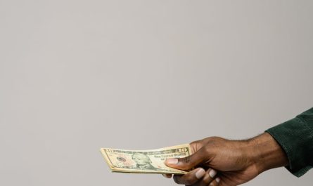 a person holding cash money