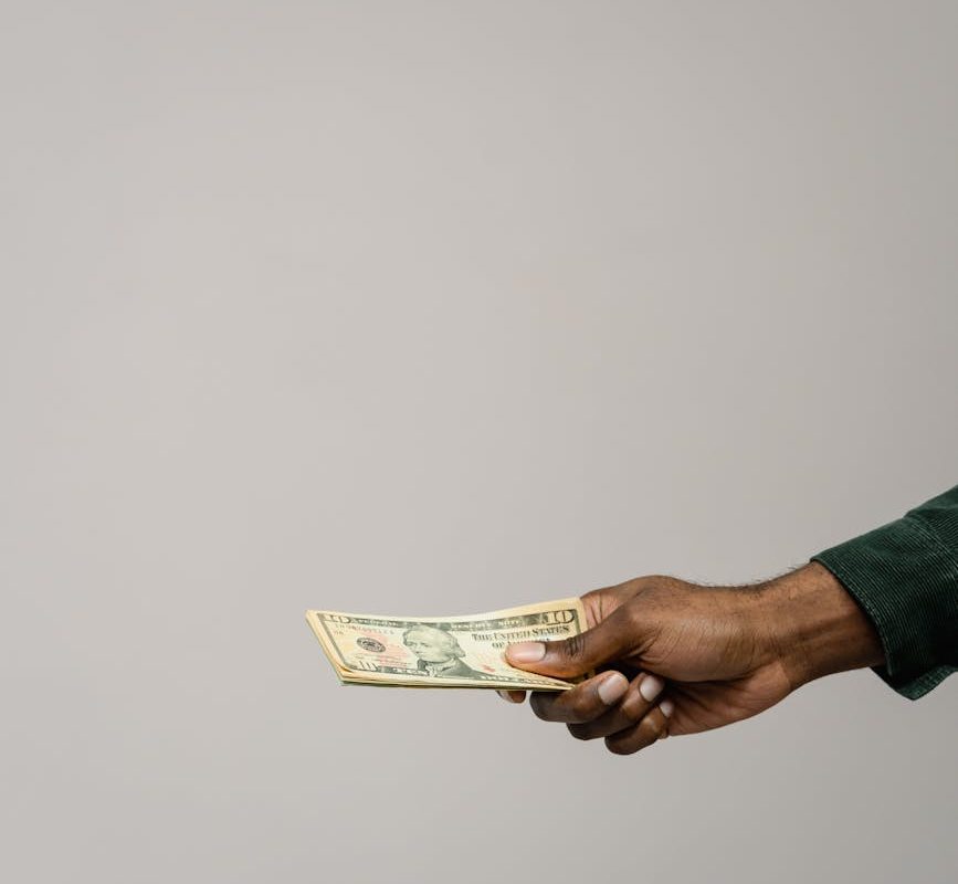 a person holding cash money