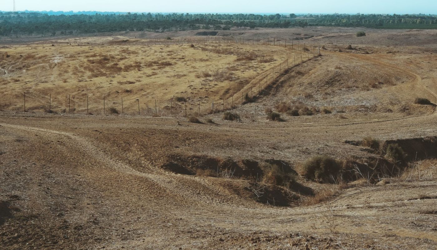 landscape of an empty land covered in soil and dry grass