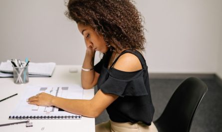 finger pointing at woman studying at the table